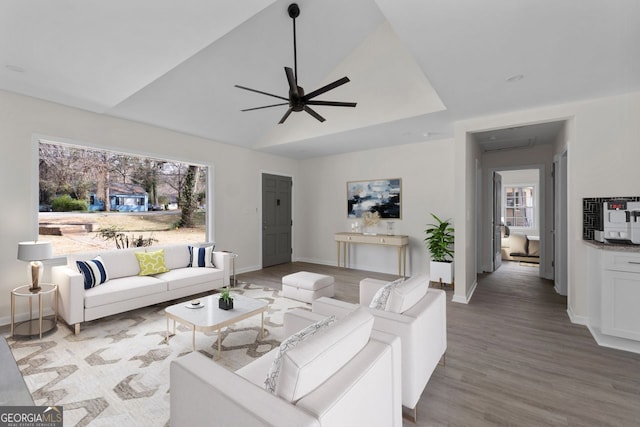 living room featuring ceiling fan, wood-type flooring, and plenty of natural light