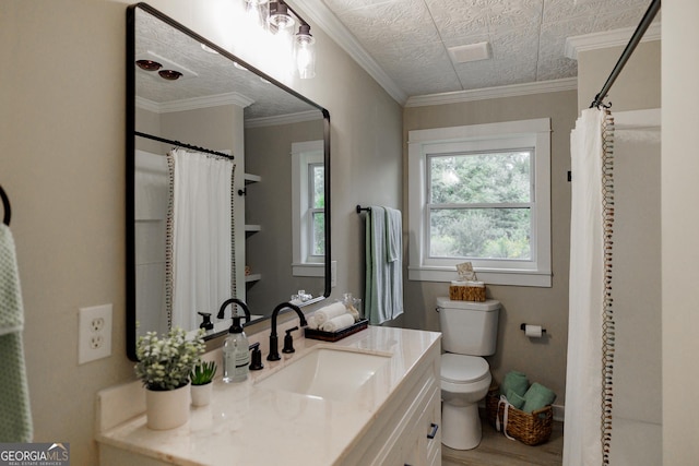 bathroom with toilet, vanity, ornamental molding, and walk in shower