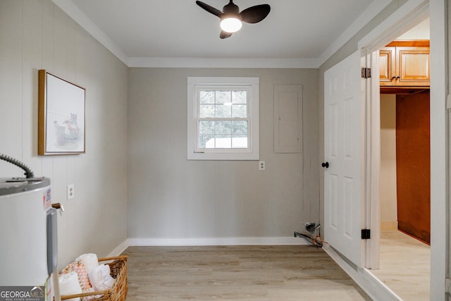 laundry area featuring ceiling fan, light hardwood / wood-style flooring, ornamental molding, and water heater