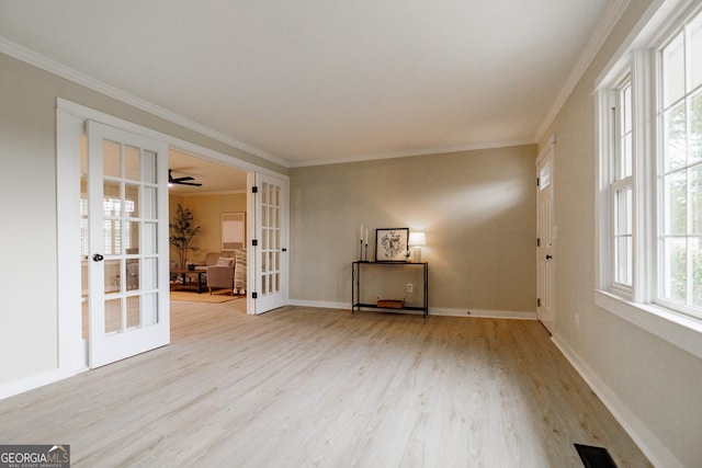 unfurnished room with light hardwood / wood-style flooring, ornamental molding, and french doors