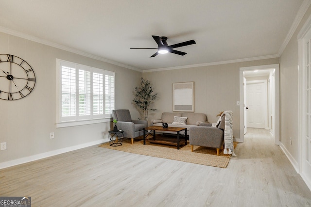 living area featuring ceiling fan, light wood-type flooring, and crown molding