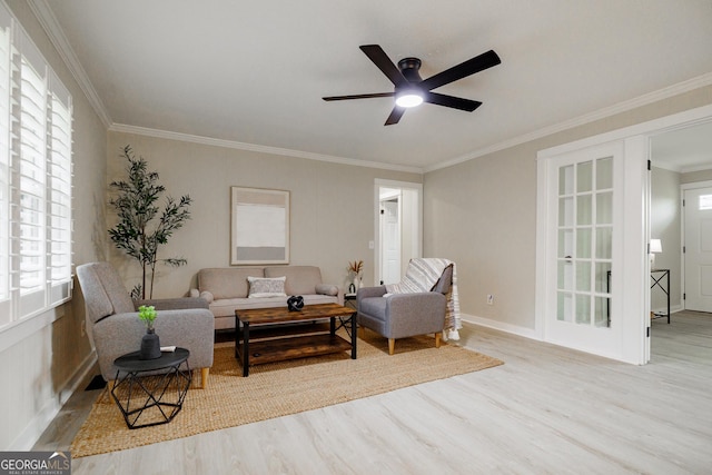 living room with ceiling fan, light hardwood / wood-style flooring, and crown molding