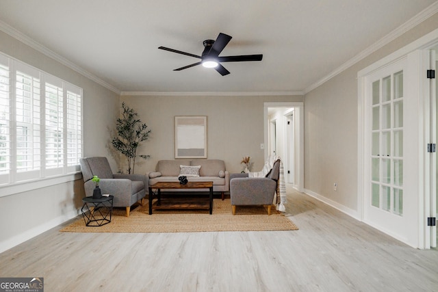 living area featuring ceiling fan, light hardwood / wood-style flooring, and crown molding