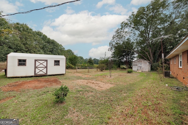 view of yard with a storage shed and central AC