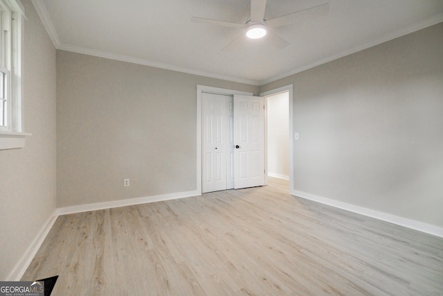 unfurnished bedroom featuring ceiling fan, a closet, crown molding, and light hardwood / wood-style floors