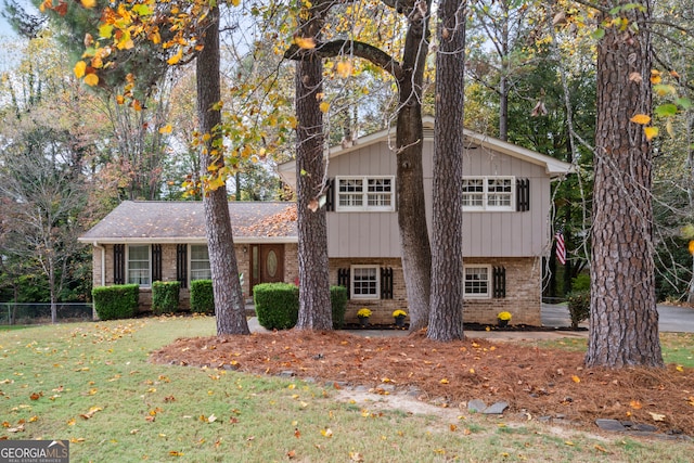 tri-level home with a front yard