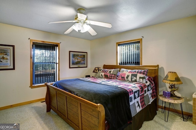 bedroom featuring light colored carpet and ceiling fan