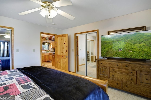 bedroom featuring light carpet, ceiling fan, and a closet