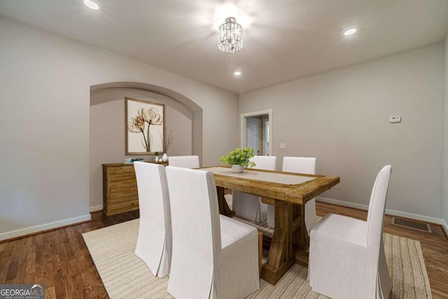 dining area featuring a chandelier and hardwood / wood-style floors