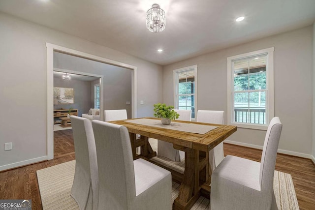 dining room with a chandelier and wood-type flooring