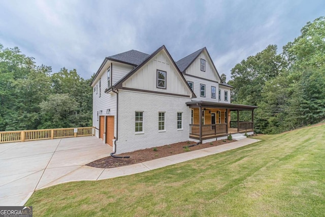 exterior space featuring a garage, a front lawn, and covered porch