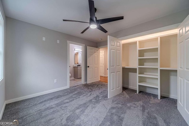 unfurnished bedroom with ceiling fan, connected bathroom, and carpet flooring