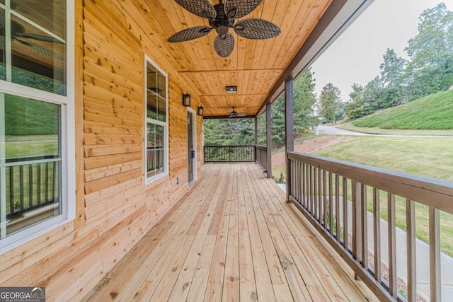 deck with covered porch and ceiling fan