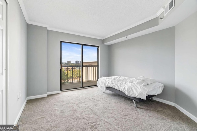 carpeted bedroom with access to outside, a textured ceiling, and crown molding