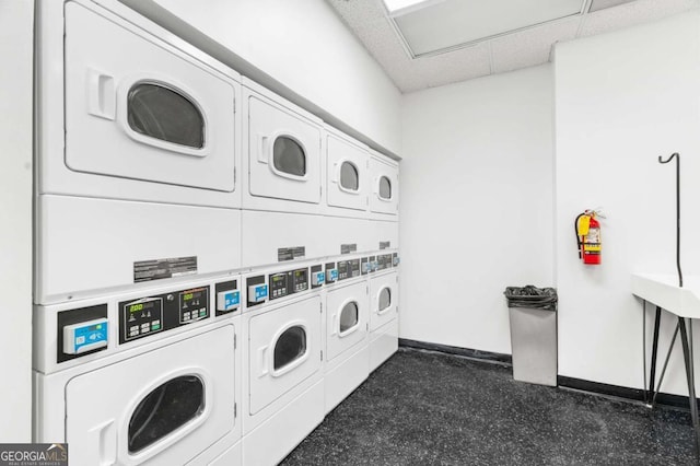 clothes washing area with stacked washer / dryer and washing machine and dryer