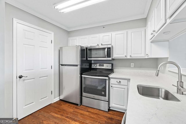 kitchen featuring stainless steel appliances, sink, ornamental molding, white cabinets, and dark hardwood / wood-style flooring