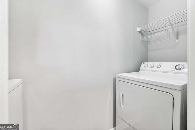 clothes washing area featuring separate washer and dryer