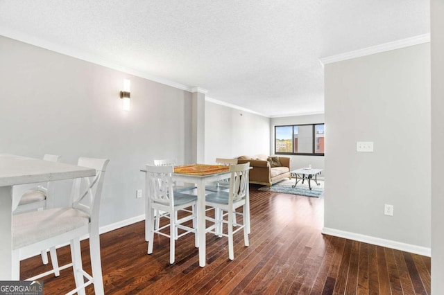 dining room featuring dark hardwood / wood-style flooring, a textured ceiling, and crown molding