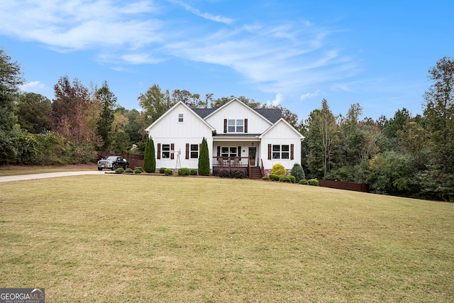 modern farmhouse style home featuring a front yard and covered porch