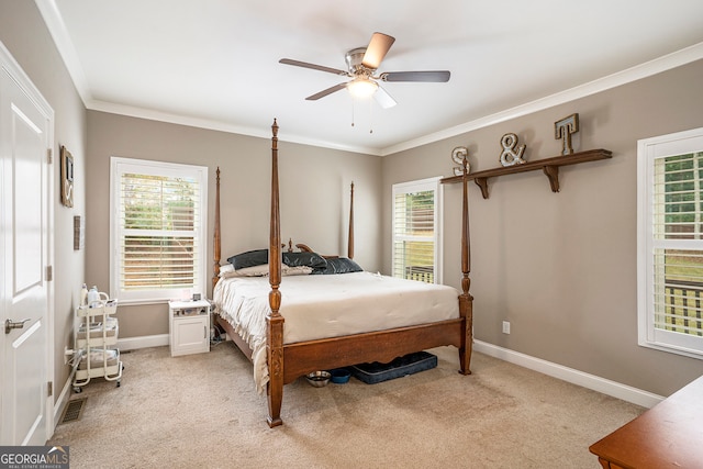 carpeted bedroom with ceiling fan and crown molding