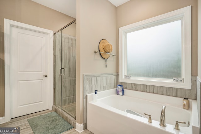 bathroom with hardwood / wood-style floors and plus walk in shower