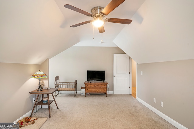 living area with ceiling fan, light carpet, and vaulted ceiling