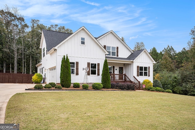 modern farmhouse style home with a front lawn, a garage, and covered porch