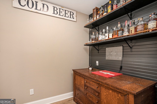 bar with hardwood / wood-style flooring