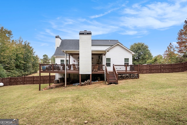 back of house featuring a wooden deck and a yard