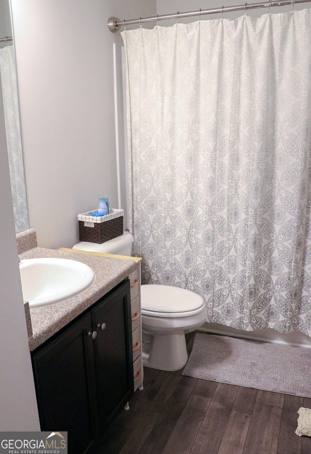 bathroom featuring hardwood / wood-style flooring, vanity, and toilet