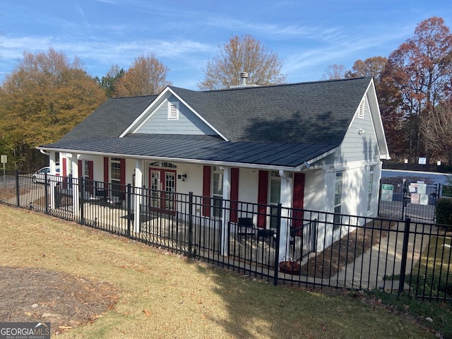 view of front of property with a porch and a front yard