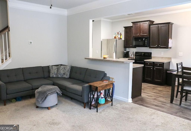 living room with light hardwood / wood-style floors and ornamental molding