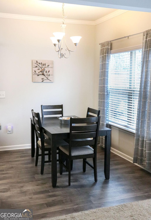 dining space with crown molding, dark hardwood / wood-style flooring, and a notable chandelier