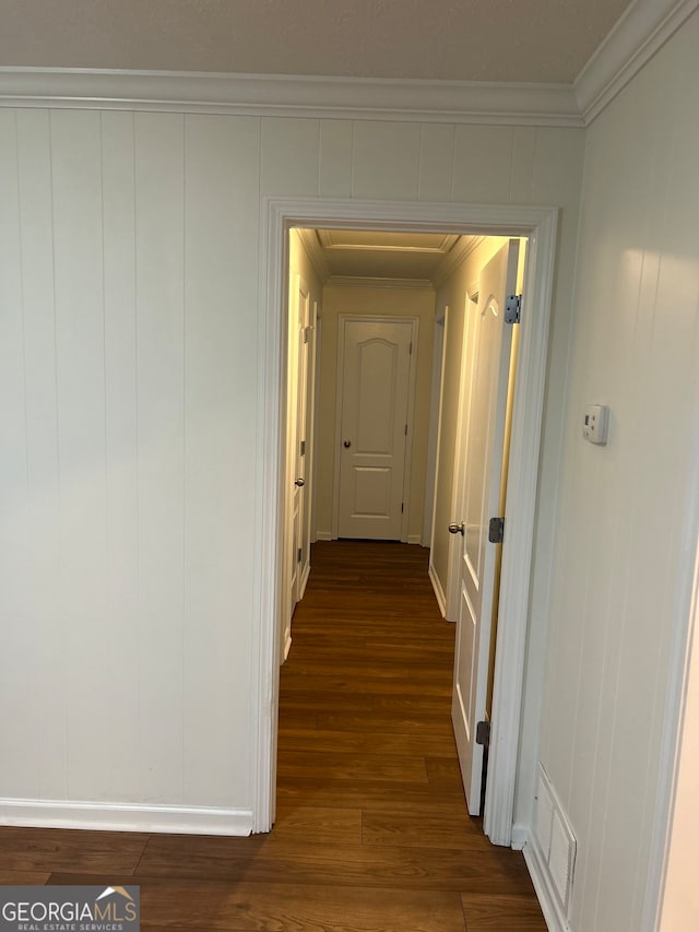 hallway featuring dark hardwood / wood-style flooring and crown molding