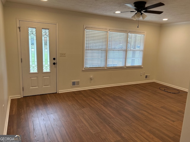 entrance foyer featuring dark wood-type flooring, ornamental molding, a textured ceiling, and ceiling fan