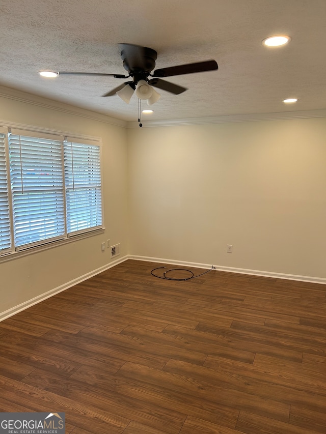 spare room with dark wood-type flooring, ceiling fan, a textured ceiling, and crown molding