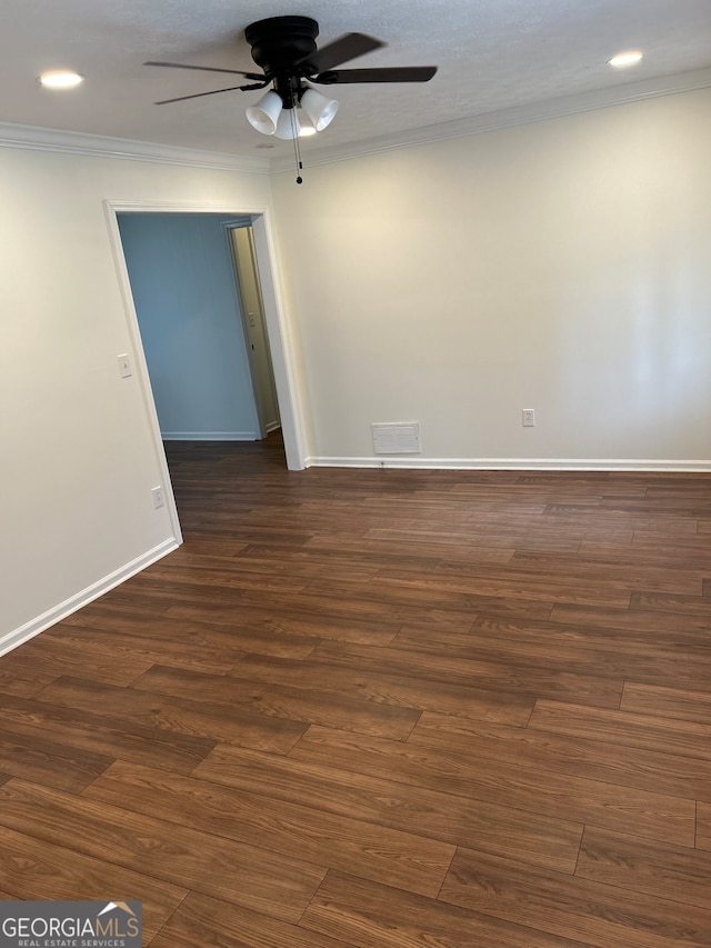 unfurnished room featuring dark hardwood / wood-style flooring, ceiling fan, and crown molding