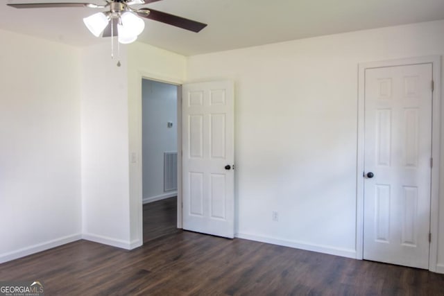 unfurnished bedroom with dark hardwood / wood-style flooring and ceiling fan