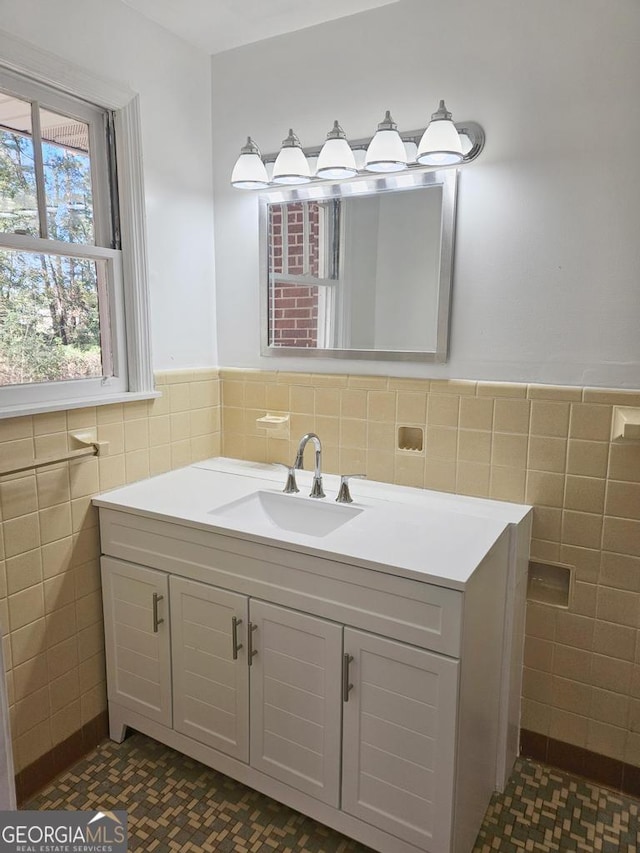 bathroom with vanity and tile walls