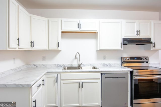 kitchen featuring white cabinets, sink, light stone countertops, and stainless steel appliances