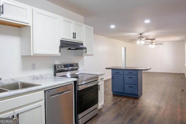 kitchen featuring dark wood-type flooring, white cabinets, stainless steel appliances, and blue cabinets