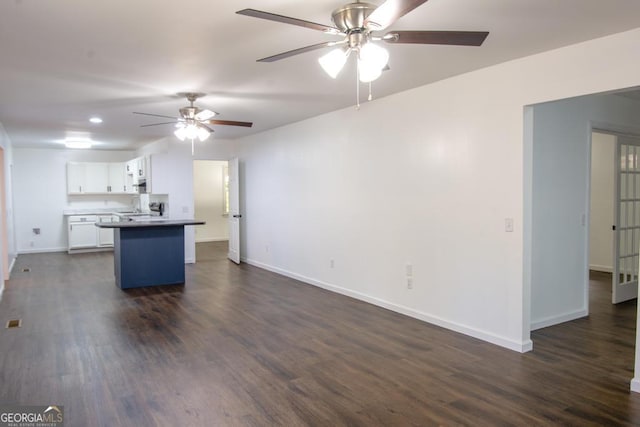 kitchen featuring dark hardwood / wood-style flooring, white cabinetry, and ceiling fan