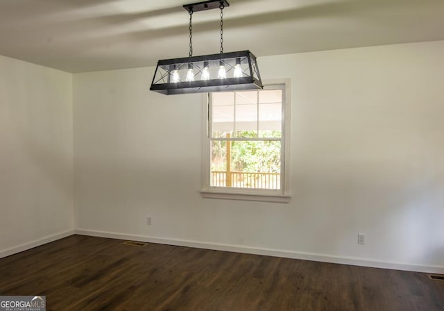 unfurnished dining area featuring dark hardwood / wood-style floors