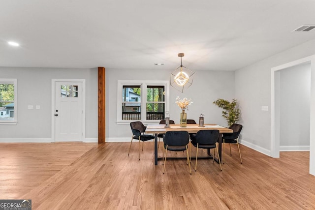 dining area with a wealth of natural light and light wood-type flooring