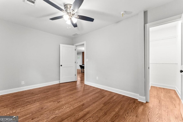 unfurnished bedroom with ceiling fan and wood-type flooring