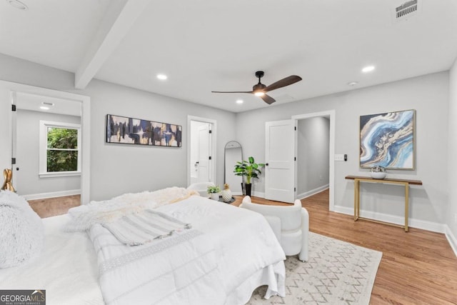 bedroom featuring light hardwood / wood-style floors, beamed ceiling, and ceiling fan