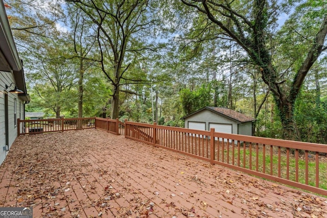 wooden deck with a garage and an outdoor structure