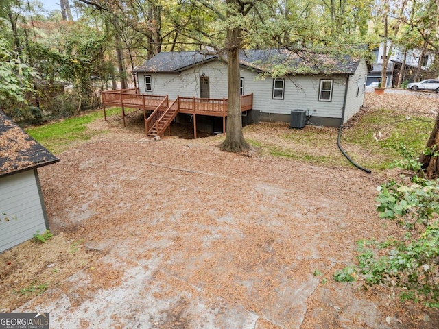 back of house featuring central AC unit and a wooden deck