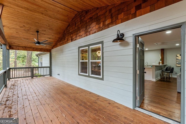 deck featuring ceiling fan and sink