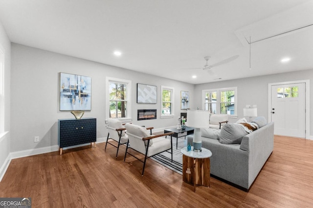 living room with hardwood / wood-style floors and ceiling fan